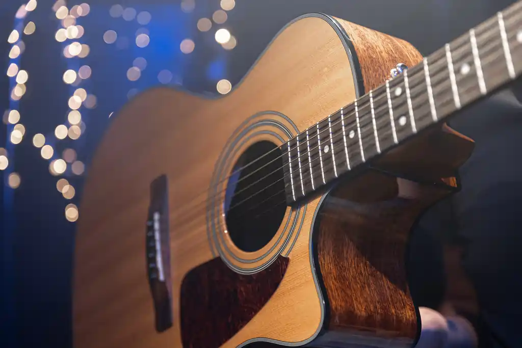 closeup-acoustic-guitar-dark-background-with-bokeh-lights (1)